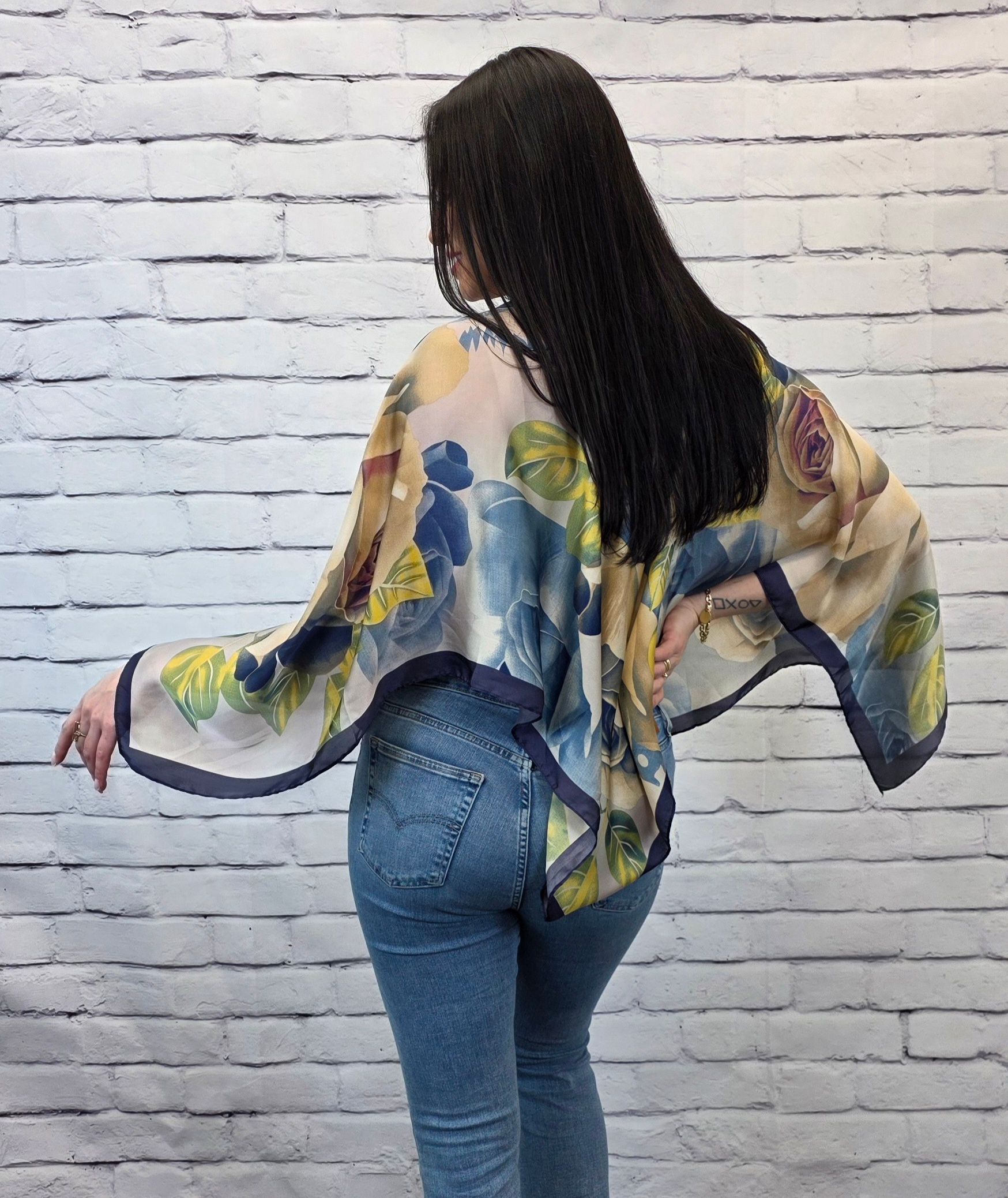 Woman wearing a silky floral cape 