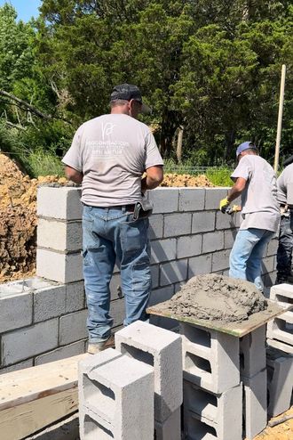 man building foundation wall