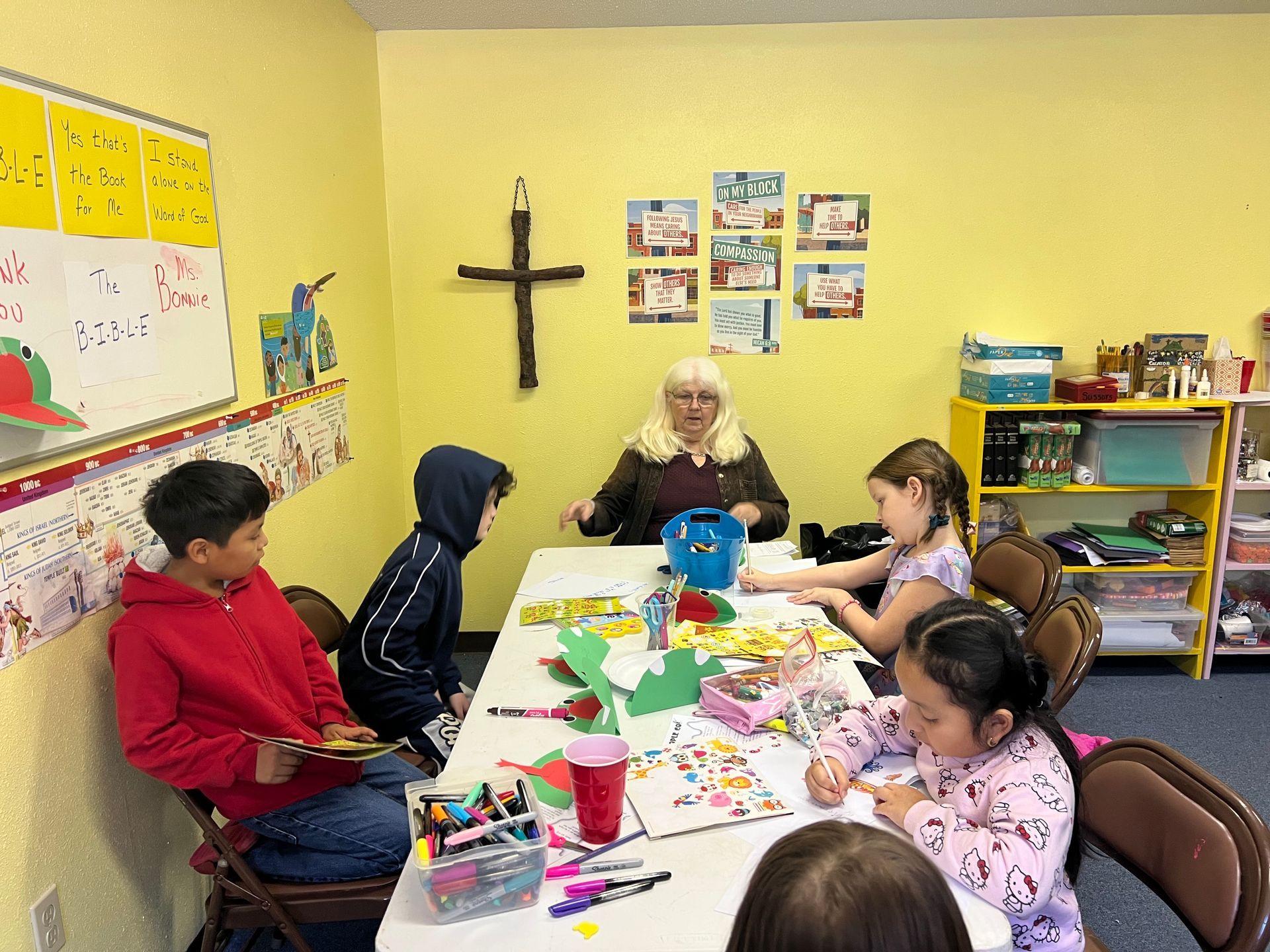 People clapping in a church. Pews filled with diverse individuals, smiling, some with children, inside a bright setting.