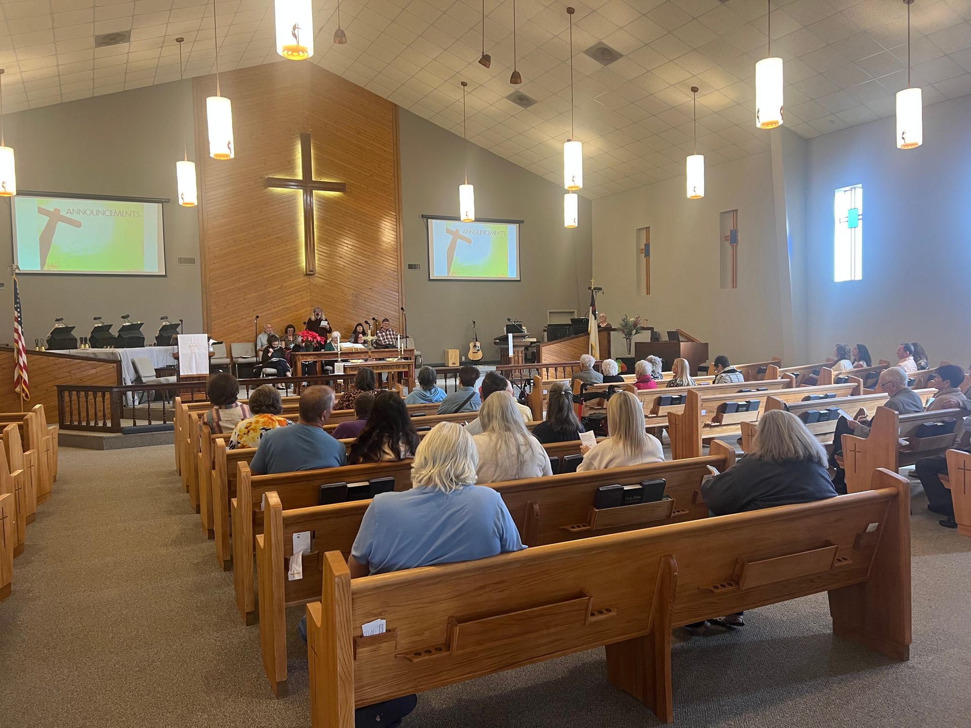 Hands clasped in prayer over an open book.