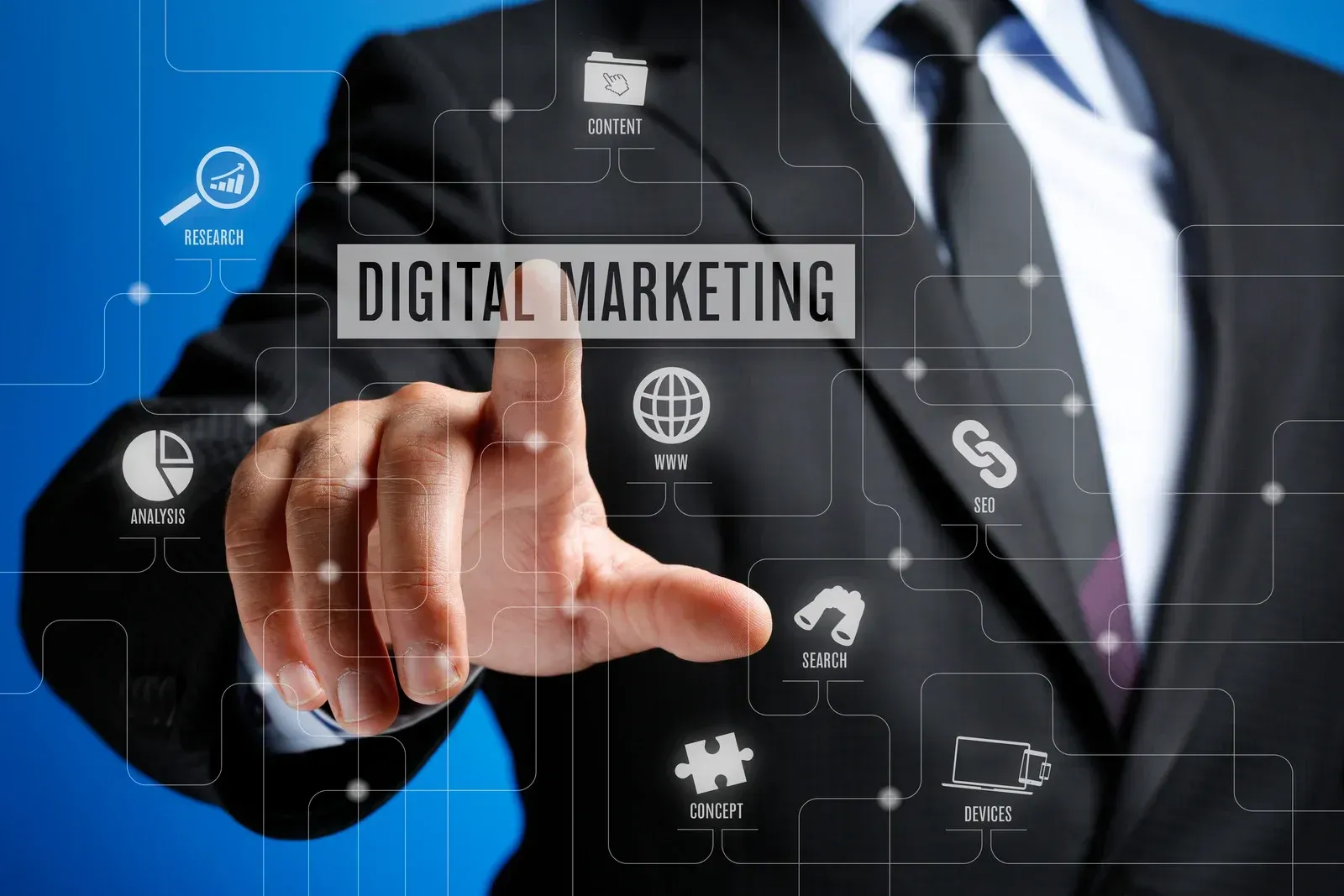 A man in a suit and tie is pressing a button that says digital marketing