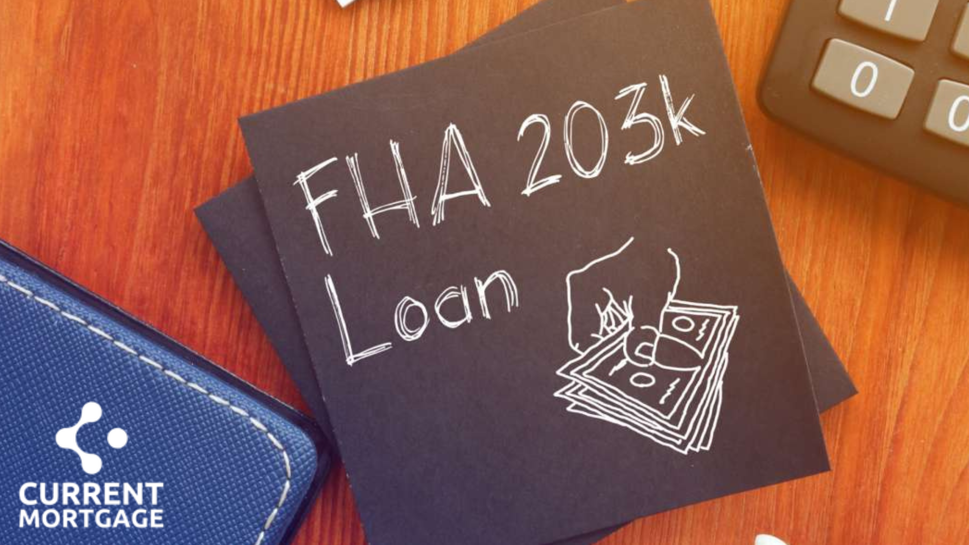 FHA 203k Loan handwritten on a black note with a drawing of a hand holding cash, set on a wooden desk.