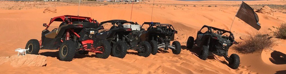 Group of UTV vehicles parked on an off-road trail in the mountains