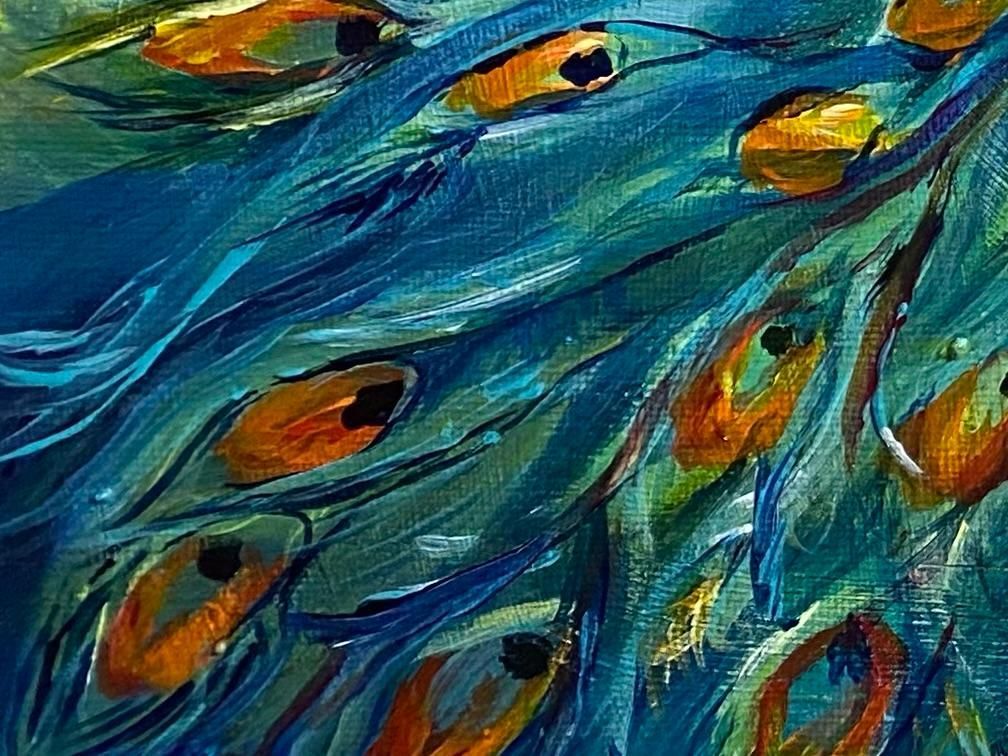 Close-up of a peacock's vibrant feathers in shades of blue, teal, and gold.