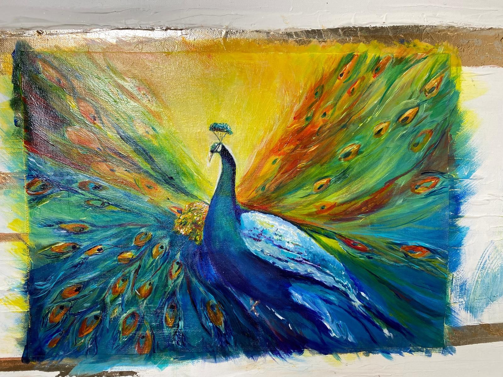 Oil pastel drawing of a peacock with a vibrant, fanned tail. Colors include blue, green, yellow, and orange.