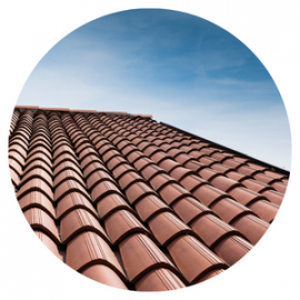 Brown clay tile roof with blue sky background.