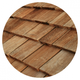 Close-up of weathered, overlapping wooden roof shingles.