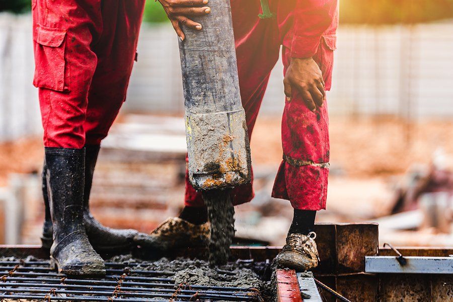 a workers pouring a cement