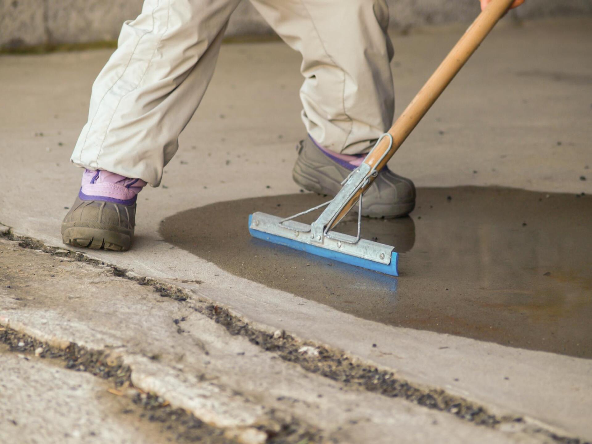 someone doing concrete sealing