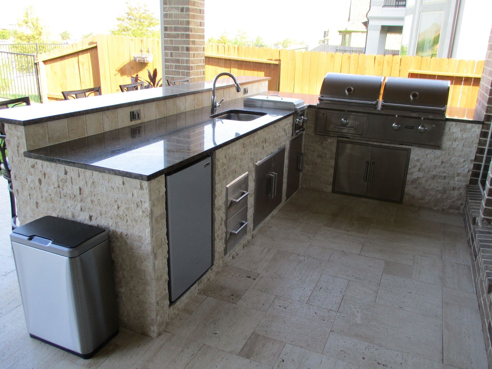 A kitchen with a trash can in front of it