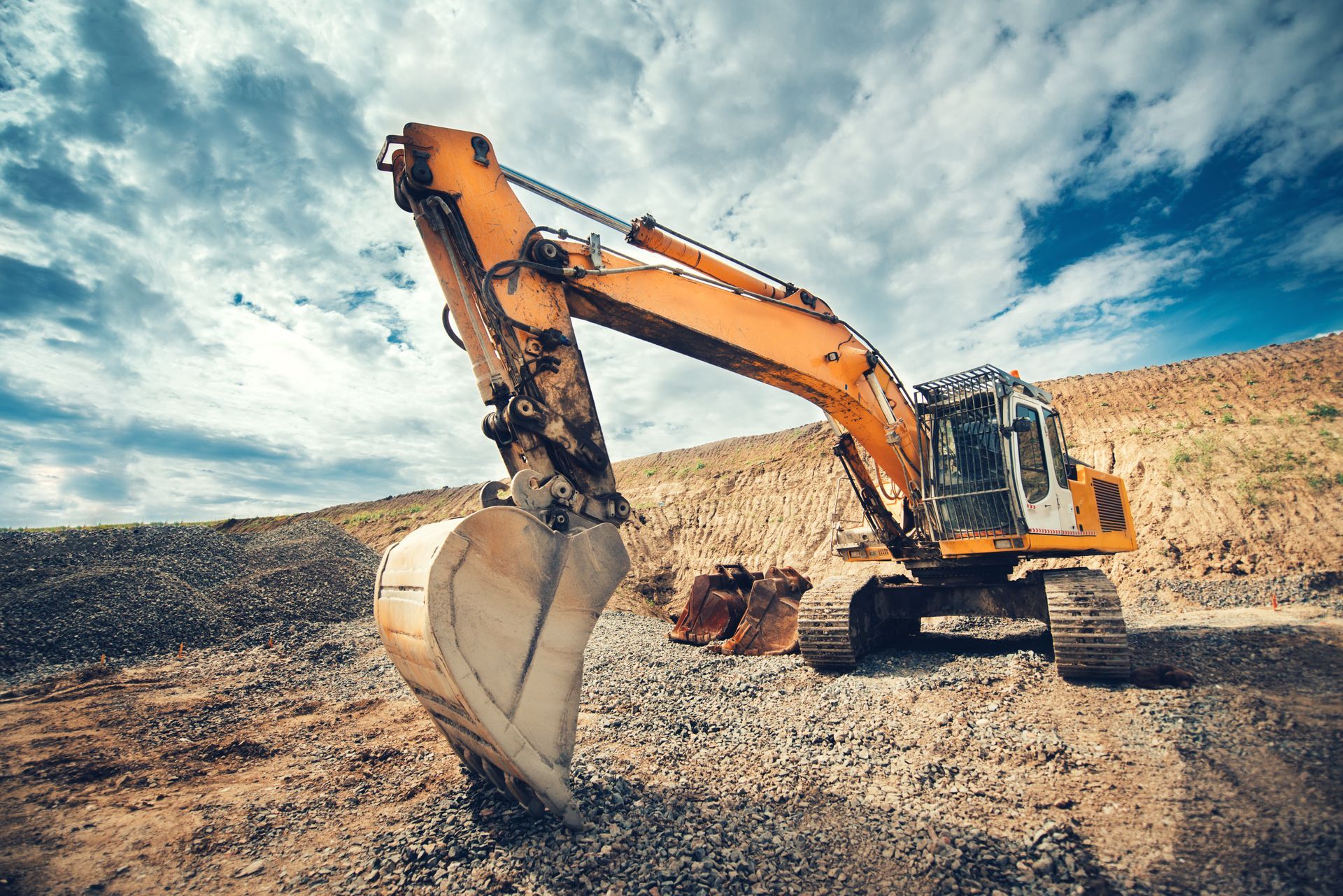Construction site with blue and grey pipes in a trench, workers, and heavy machinery. Construction site with blue and grey pipes in a trench, workers, and heavy machinery.