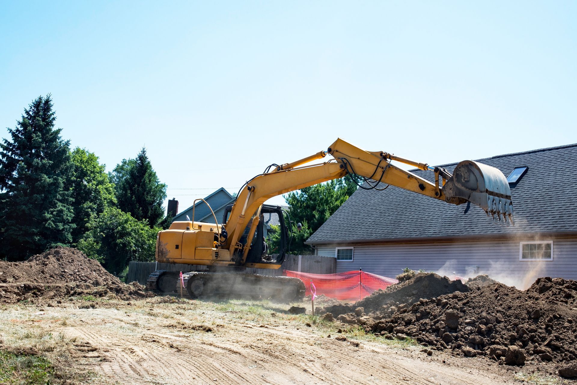 Yellow excavator digging trench for pipe in backyard. Yellow excavator digging trench for pipe in backyard.