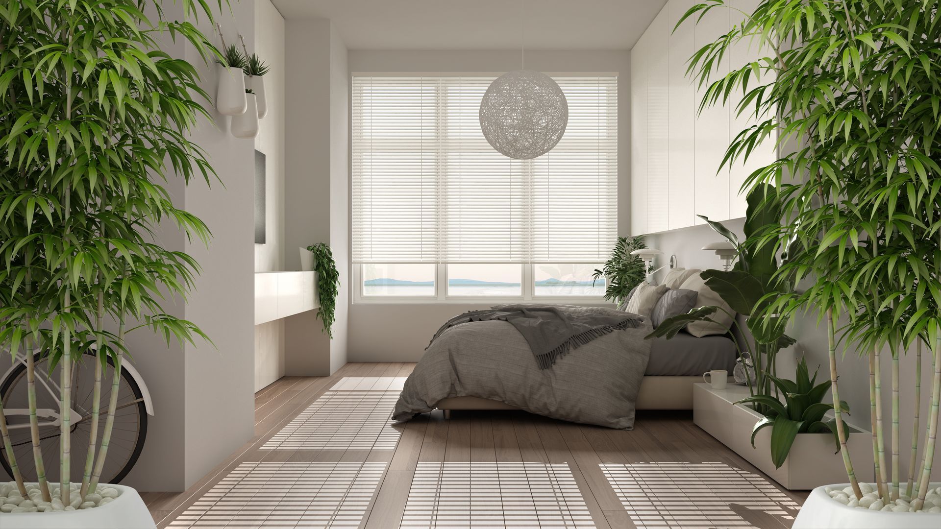 A clean, modern bedroom with a wide window, soft bedding, and lush house plants.