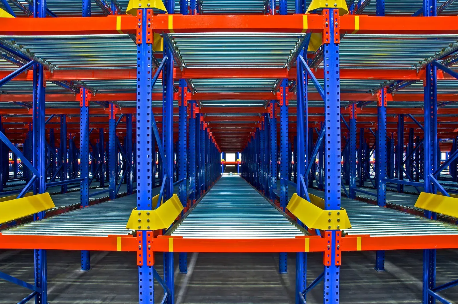 A warehouse filled with lots of shelves and conveyor belts.