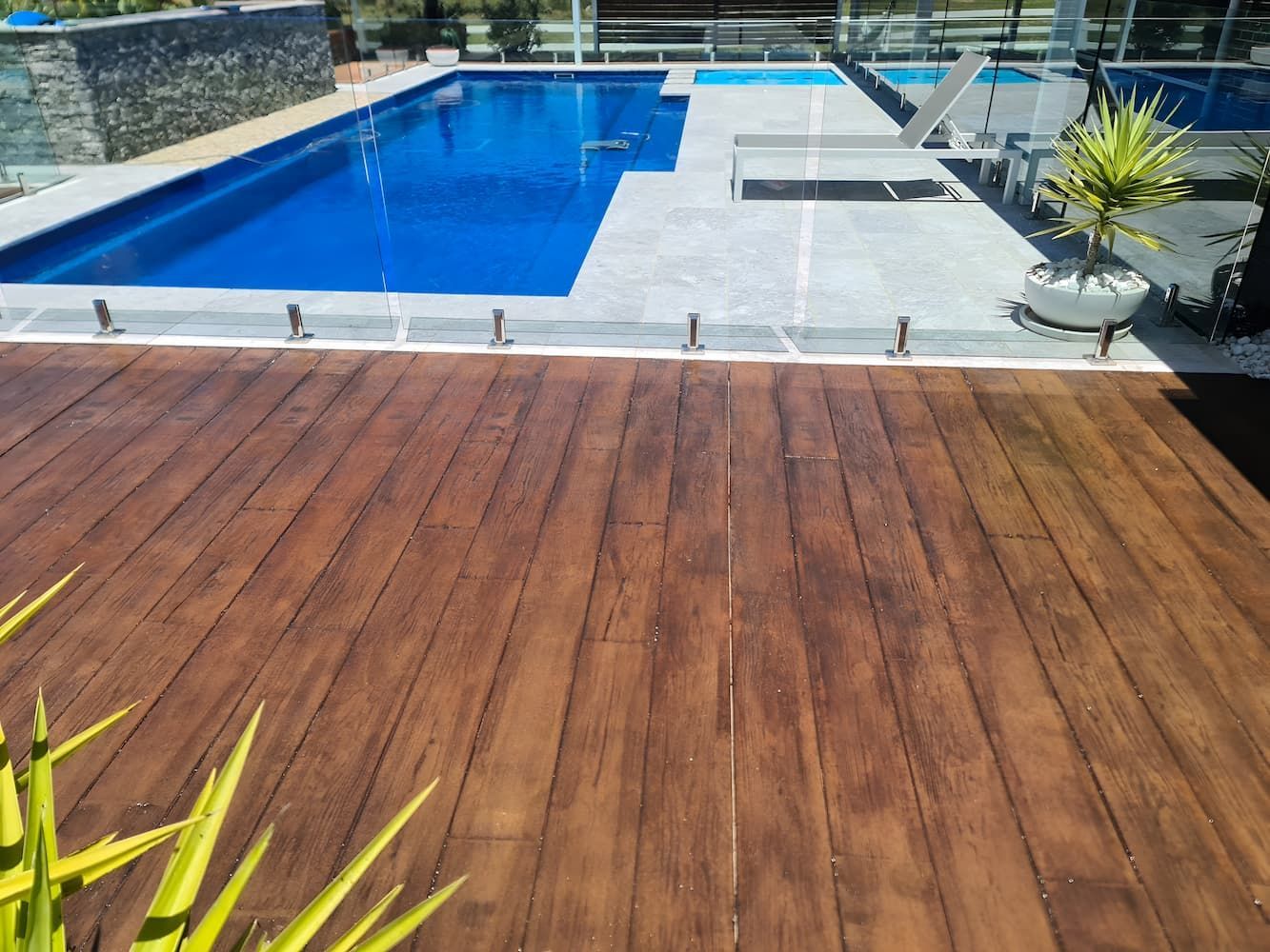 A large swimming pool with a wooden deck in front of it— That Painter Guy In South Nowra, NSW