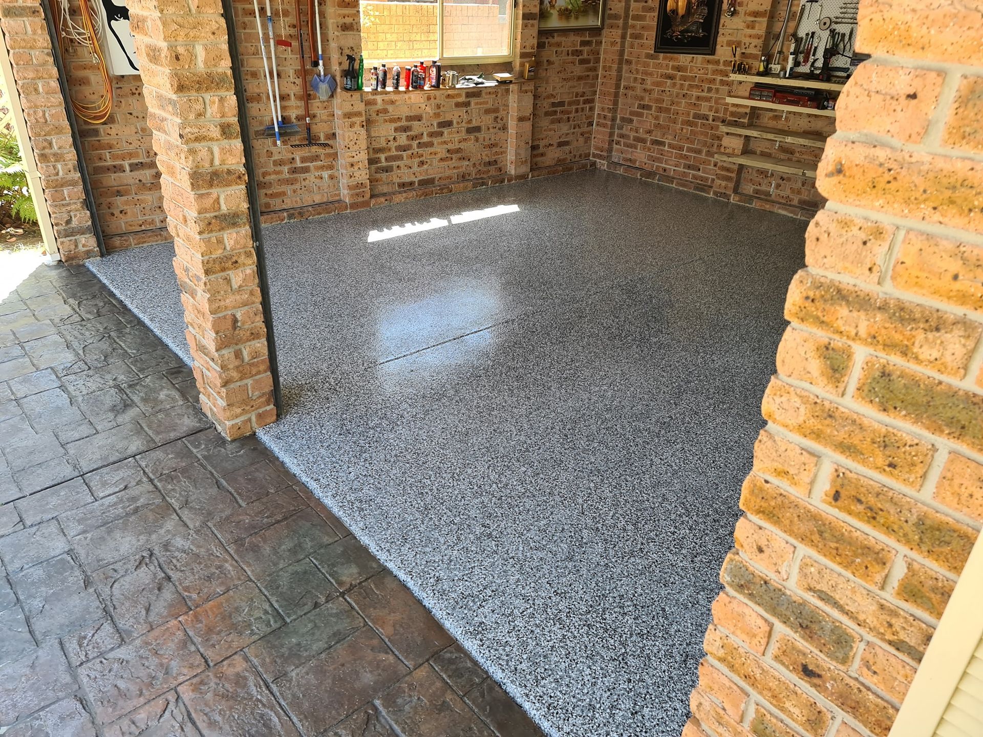 A garage with a concrete floor and brick walls.— That Painter Guy In South Nowra, NSW