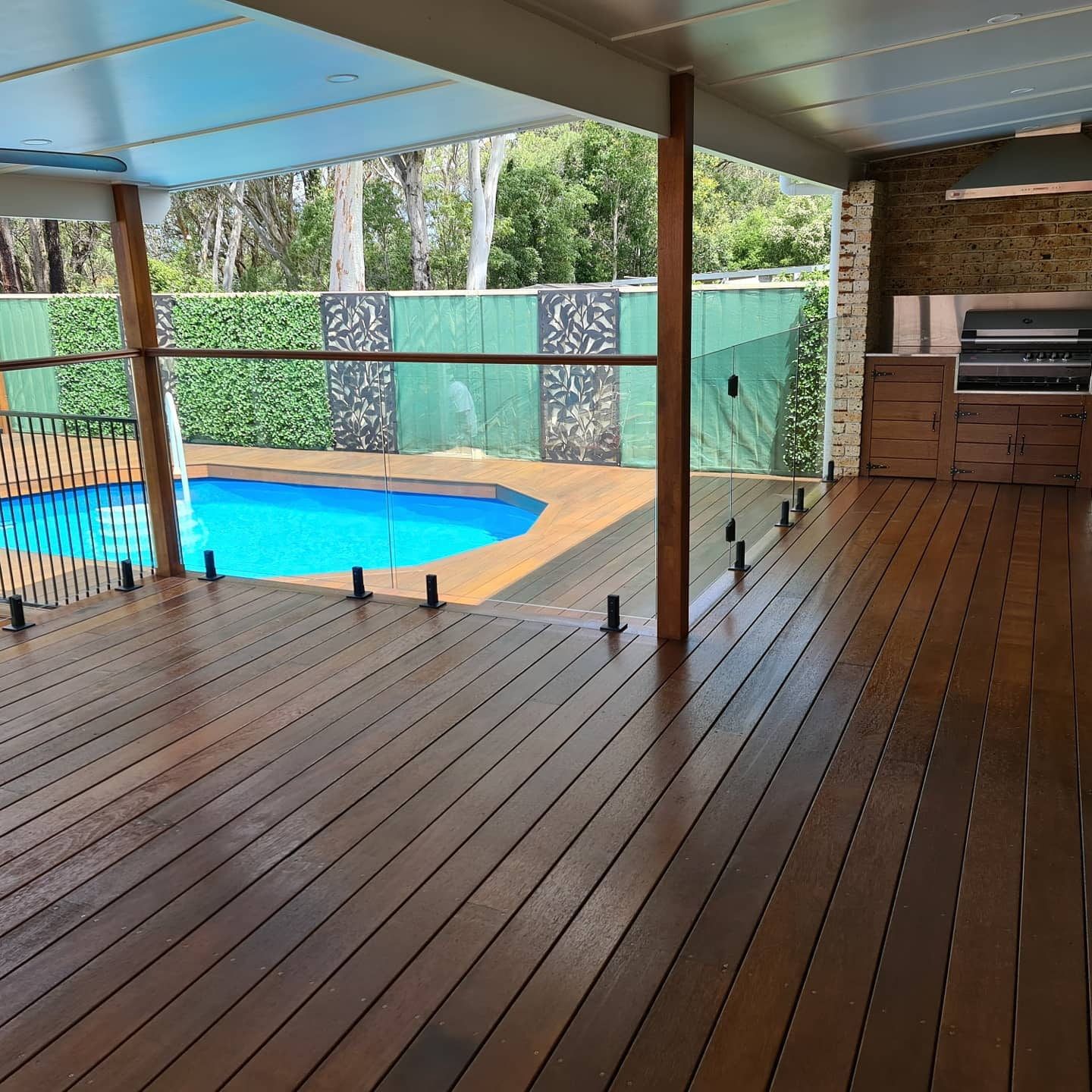 A wooden deck with a swimming pool in the background — That Painter Guy In South Nowra, NSW