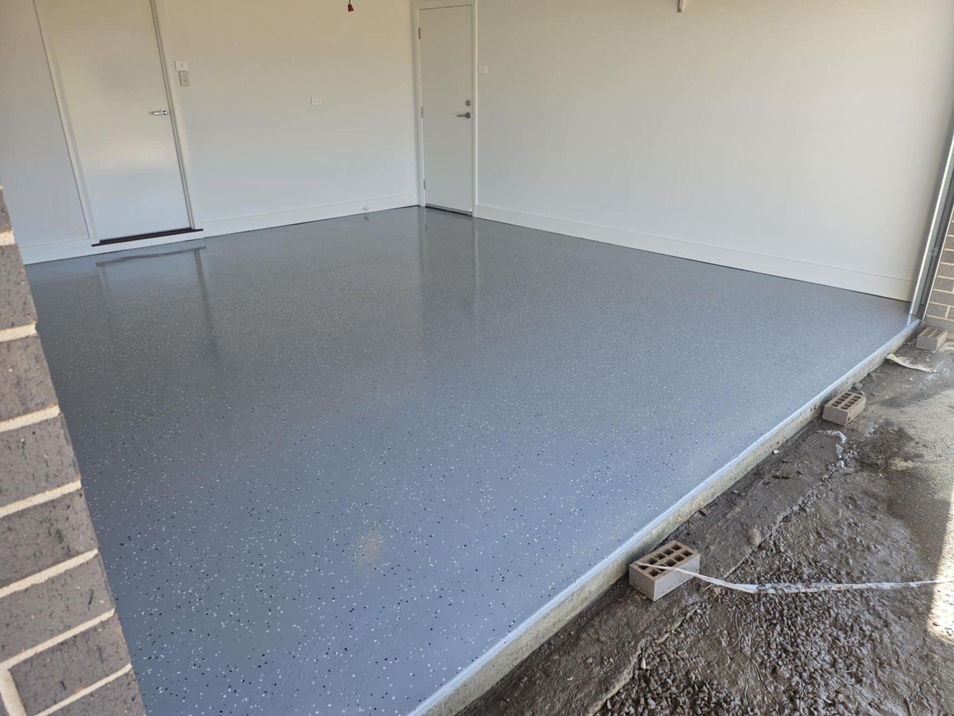 A garage with a gray floor and a white door.— That Painter Guy In South Nowra, NSW