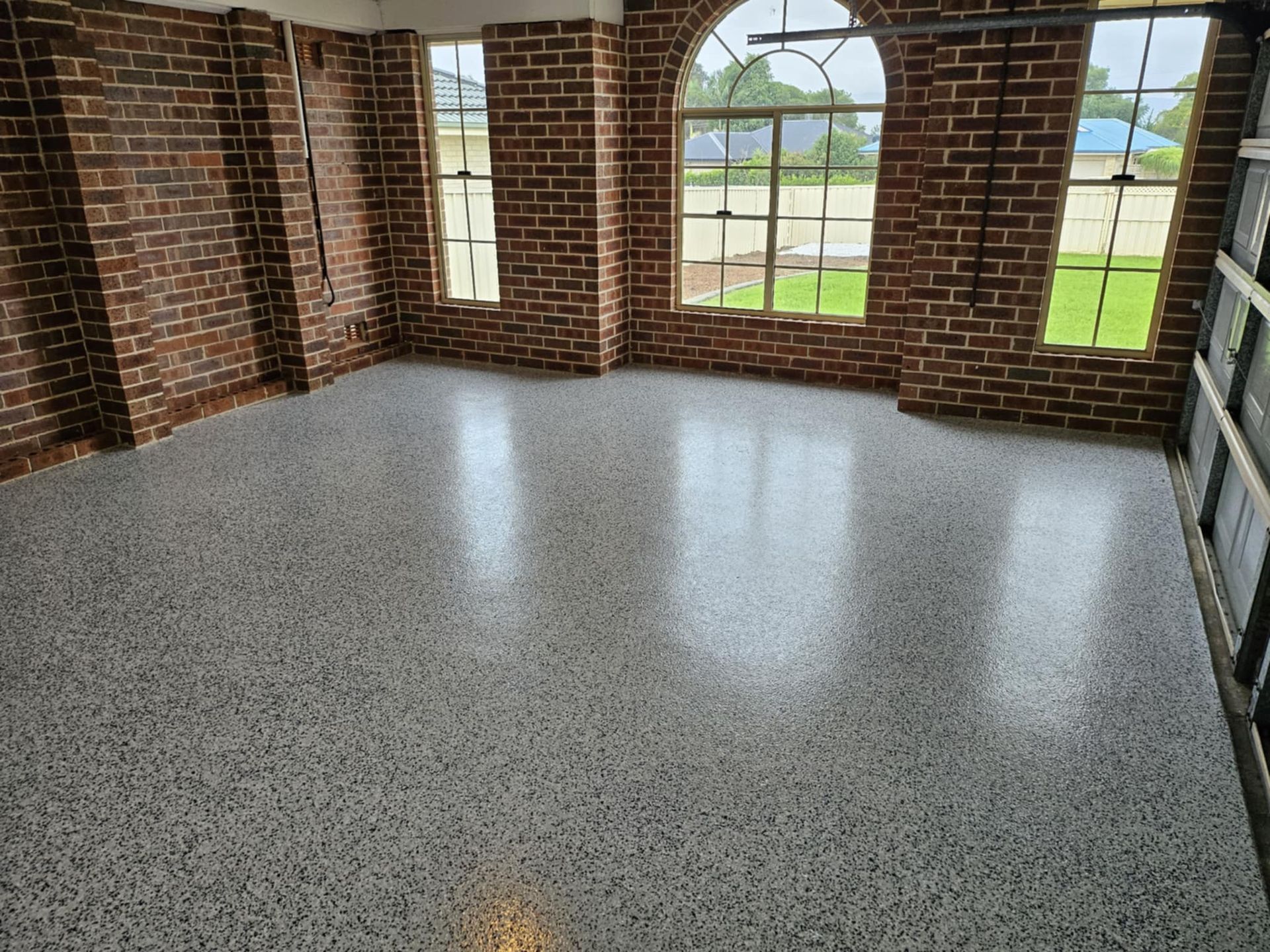 A large room with brick walls and a concrete floor.— That Painter Guy In South Nowra, NSW