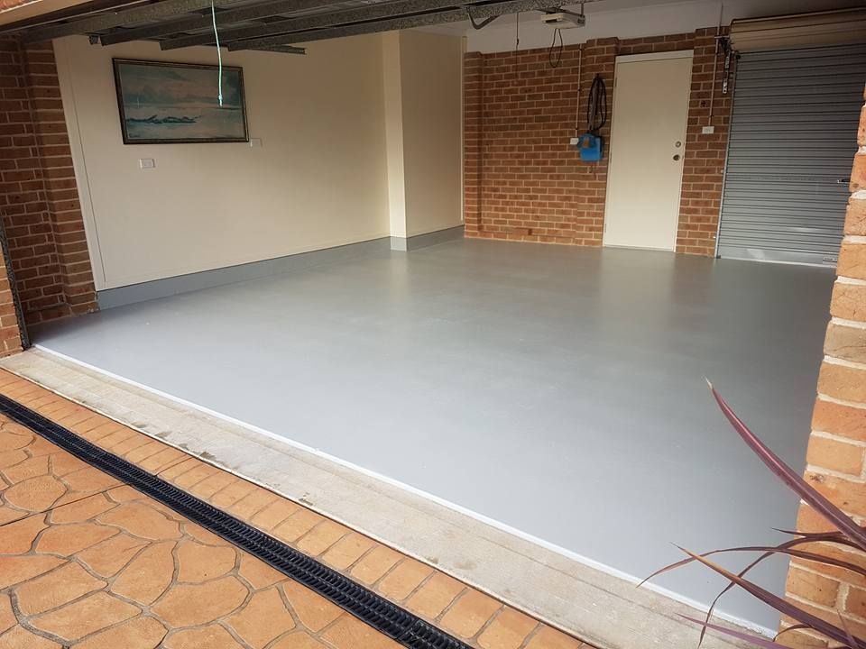 A garage with a brick wall and a gray floor.— That Painter Guy In South Nowra, NSW