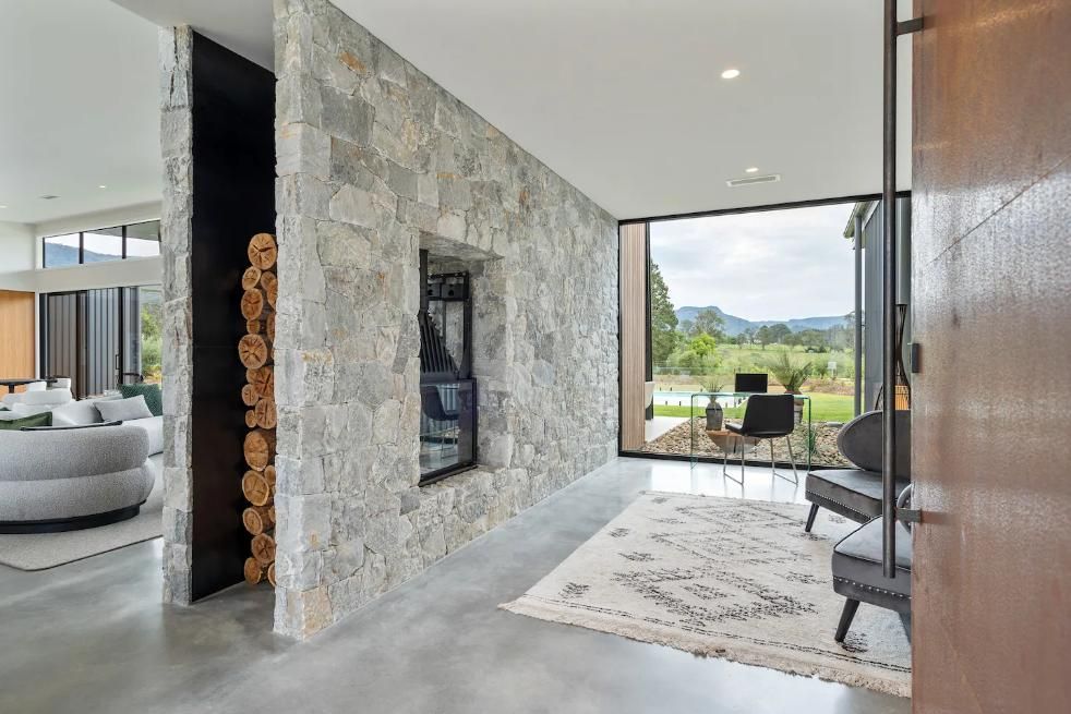 A Living Room With A Stone Wall and A Large Window  — That Painter Guy In South Nowra, NSW