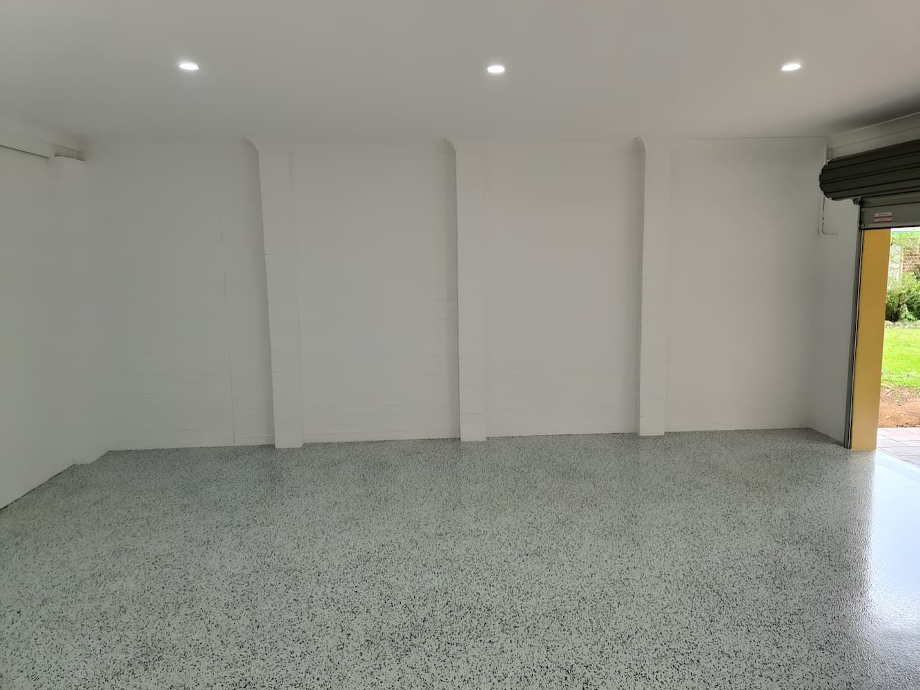 An Empty Garage With A Gray Floor And White Walls — That Painter Guy In South Nowra, NSW