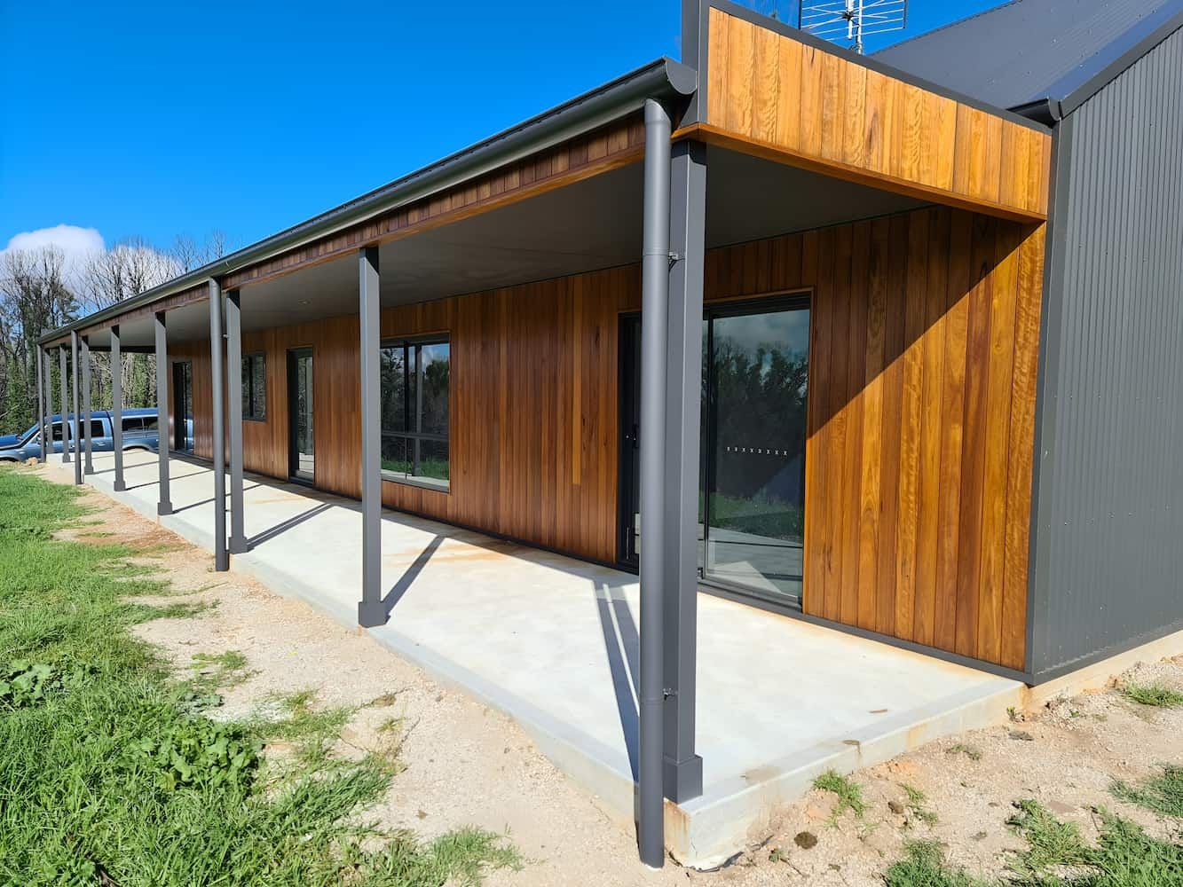 A Large House With A Wooden Siding And A Concrete Walkway — That Painter Guy In South Nowra, NSW