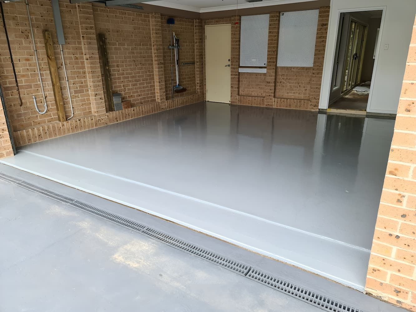 A Garage With A Brick Wall And A Gray Floor — That Painter Guy In South Nowra, NSW