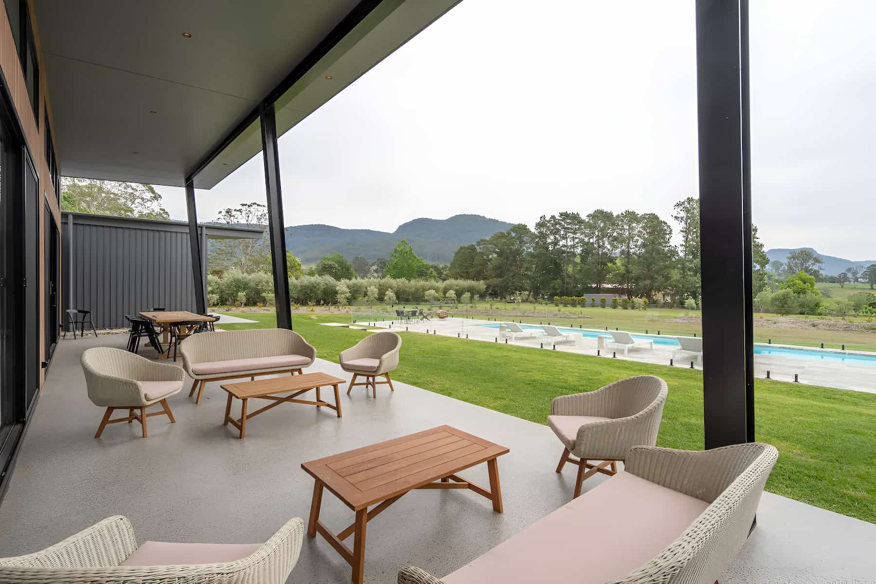 A Patio With A Lot Of Furniture And A Swimming Pool In The Background — That Painter Guy In South Nowra, NSW