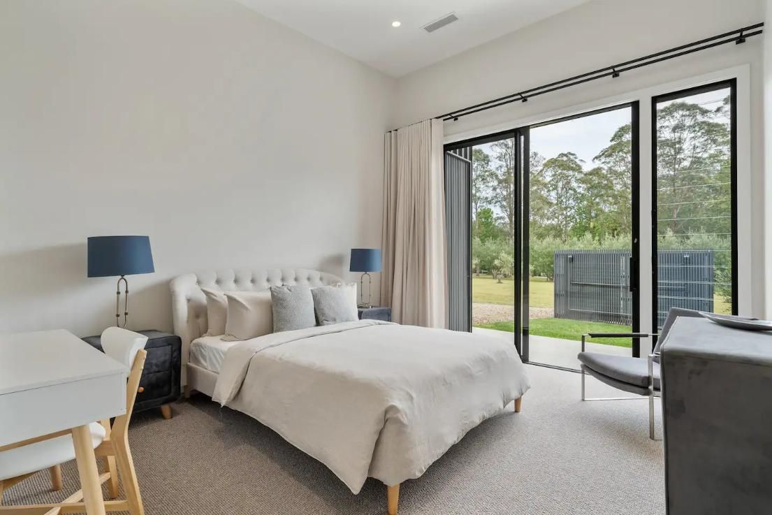 A Bedroom With A Large Bed , Desk , Chair and Sliding Glass Doors  — That Painter Guy In South Nowra, NSW