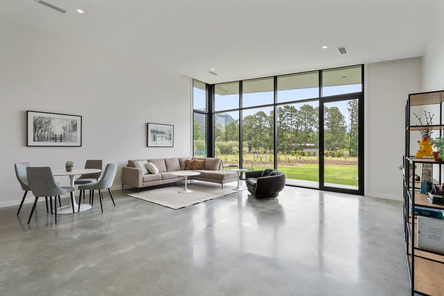 A living room with a couch , chairs , a table and a lot of windows.— That Painter Guy In South Nowra, NSW