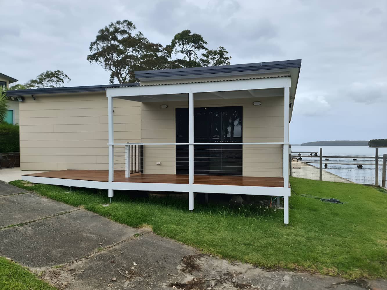 A Small House With A Deck Overlooking A Body Of Water — That Painter Guy In South Nowra, NSW