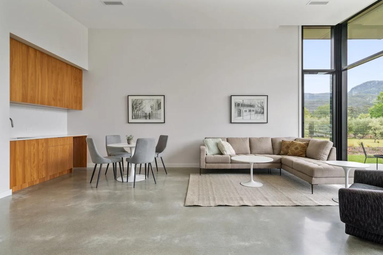 A Living Room With A Couch , Chairs , A Table and A Large Window  — That Painter Guy In South Nowra, NSW