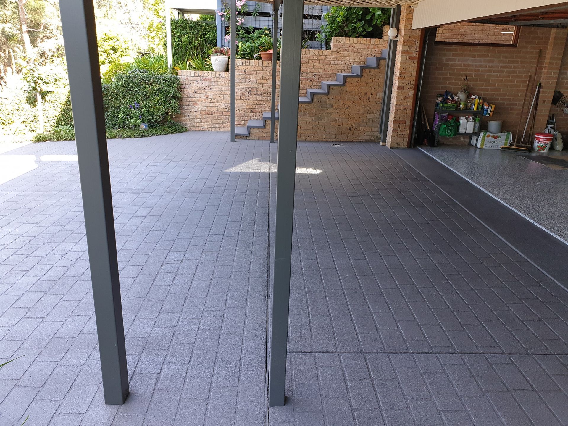 A brick driveway with stairs leading up to a garage— That Painter Guy In South Nowra, NSW