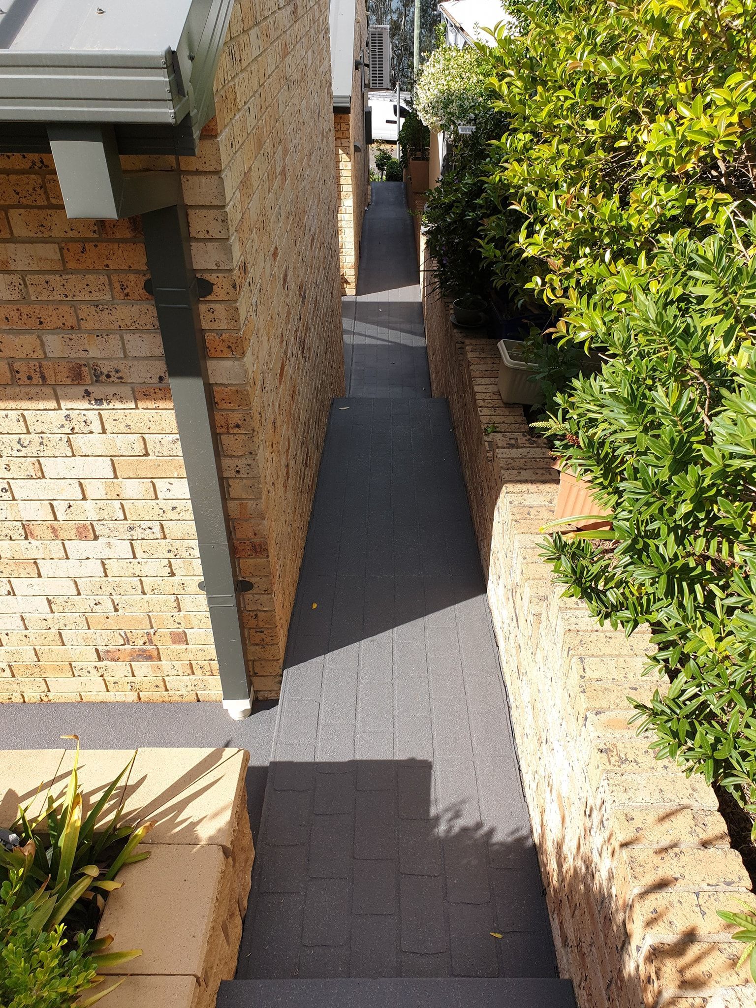 A narrow walkway between two brick buildings— That Painter Guy In South Nowra, NSW