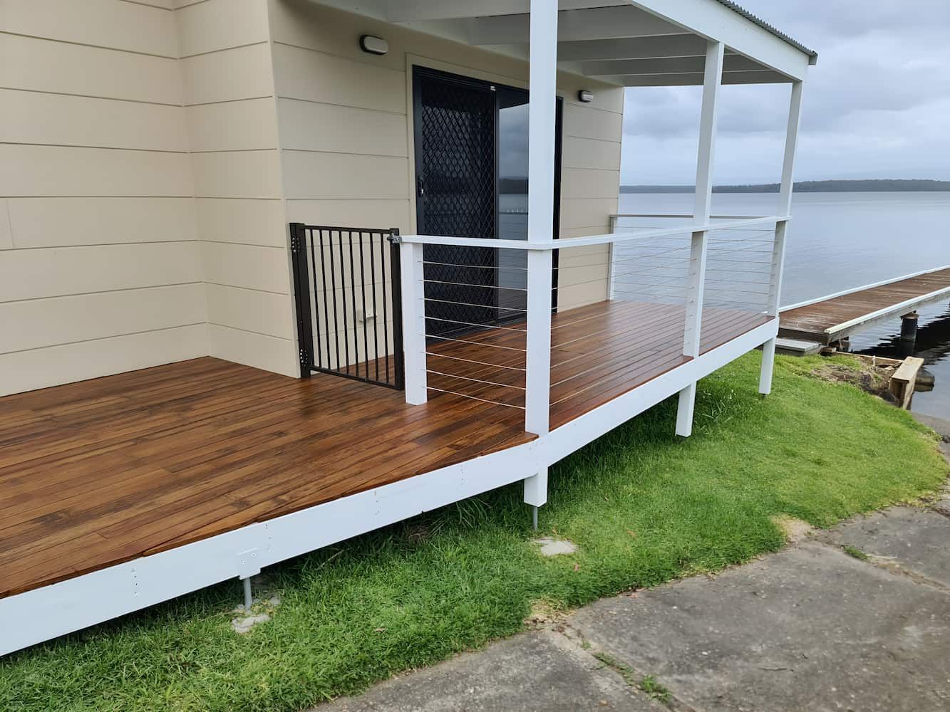 A House With A Wooden Deck Overlooking A Body Of Water — That Painter Guy In South Nowra, NSW
