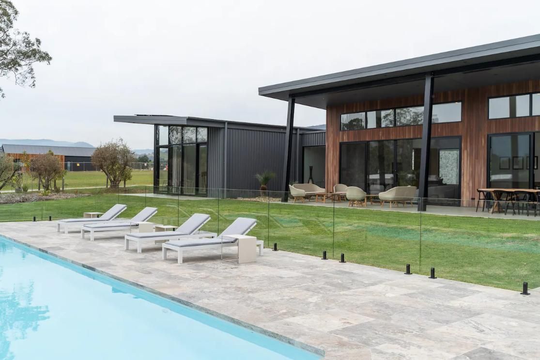 A Large House With A Swimming Pool In Front Of It  — That Painter Guy In South Nowra, NSW