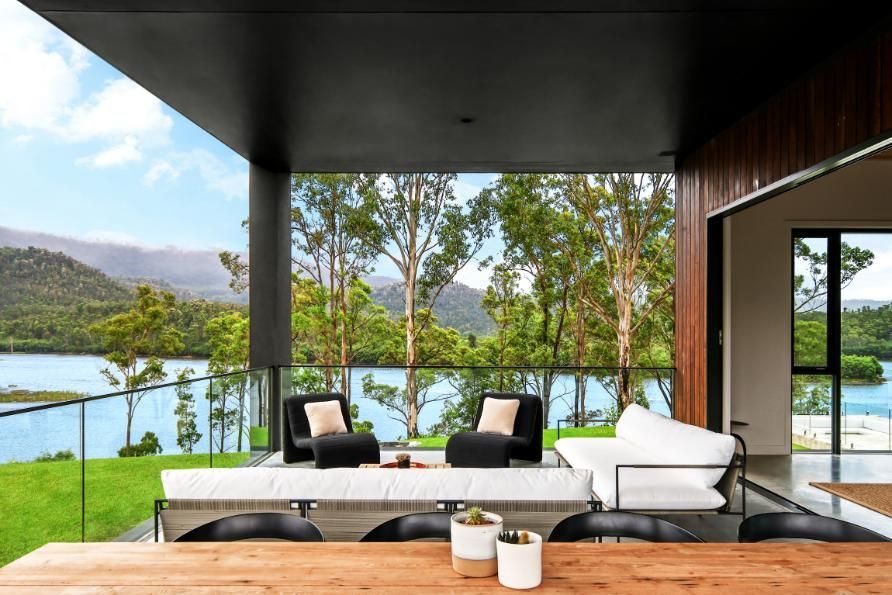 A Balcony With A Table and Chairs Overlooking A Lake  — That Painter Guy In South Nowra, NSW