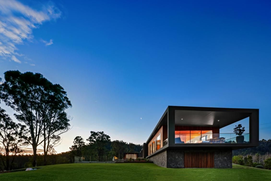 A Large House With A Lot Of Windows Is Surrounded By Grass and Trees  — That Painter Guy In South Nowra, NSW