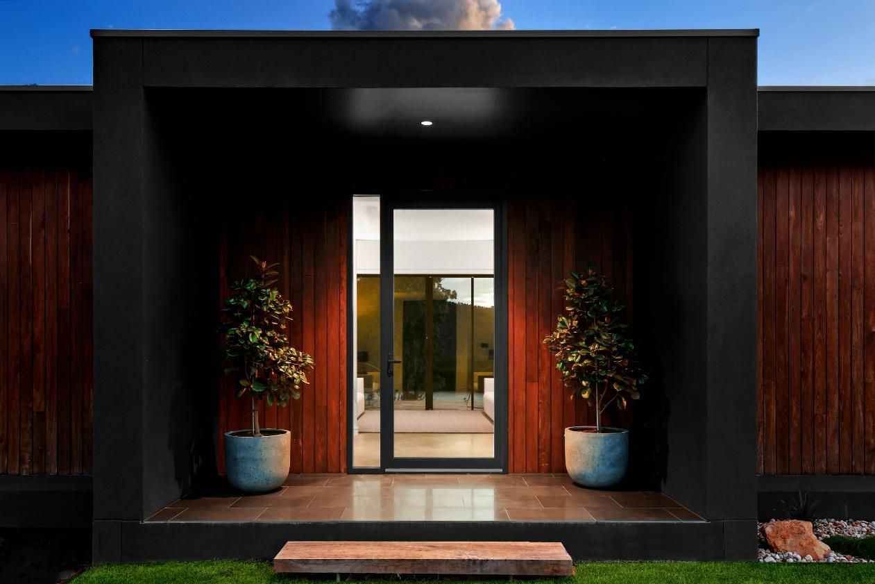 A Modern House with A Large Glass Door and Potted Plants — That Painter Guy In South Nowra, NSW