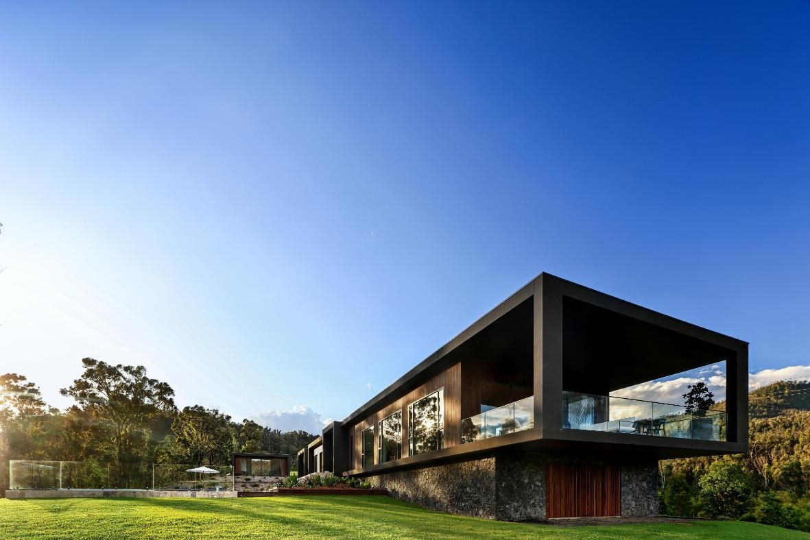 A Modern House Is Sitting On Top Of A Lush Green Hillside  — That Painter Guy In South Nowra, NSW