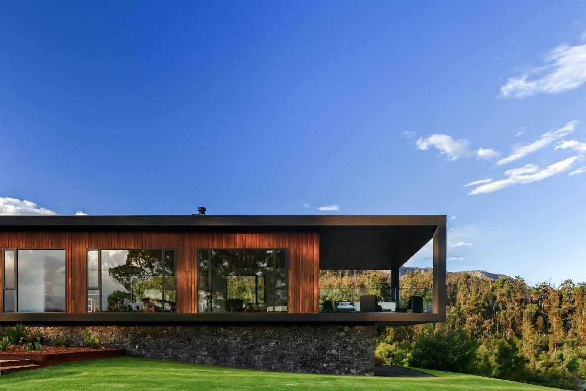 A Modern House Is Sitting On Top Of A Lush Green Hillside  — That Painter Guy In South Nowra, NSW