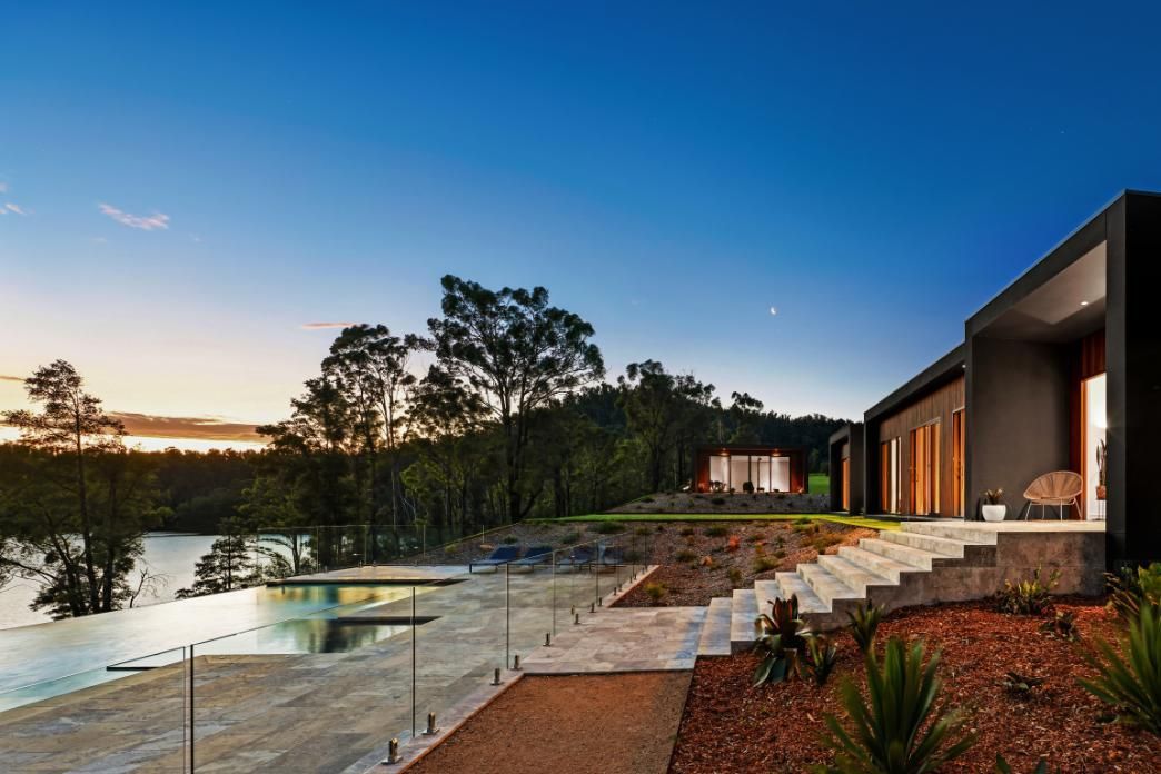 A Modern House With Stairs Leading Up To A Lake Surrounded By Trees  — That Painter Guy In South Nowra, NSW