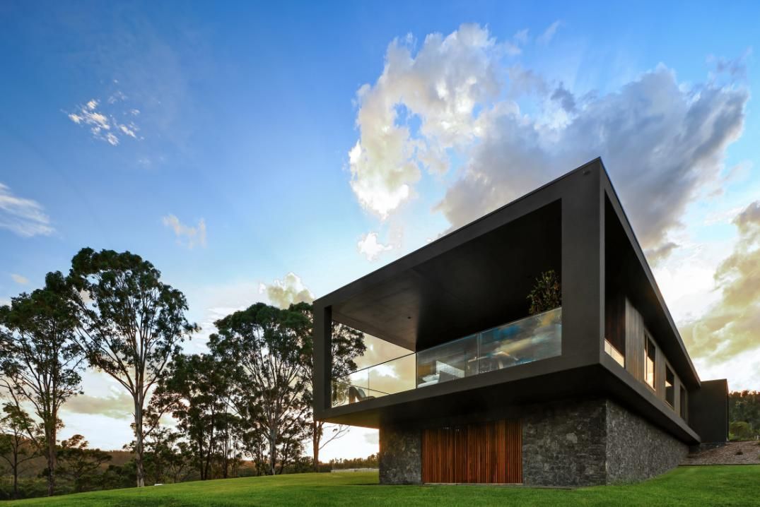 Modern House Is Sitting On Top Of A Lush Green Hillside Surrounded By Trees  — That Painter Guy In South Nowra, NSW