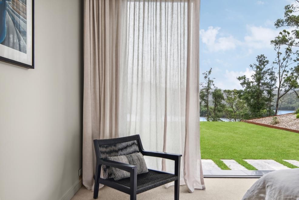 Bedroom With A Chair and A Sliding Glass Door Leading To A Lawn  — That Painter Guy In South Nowra, NSW