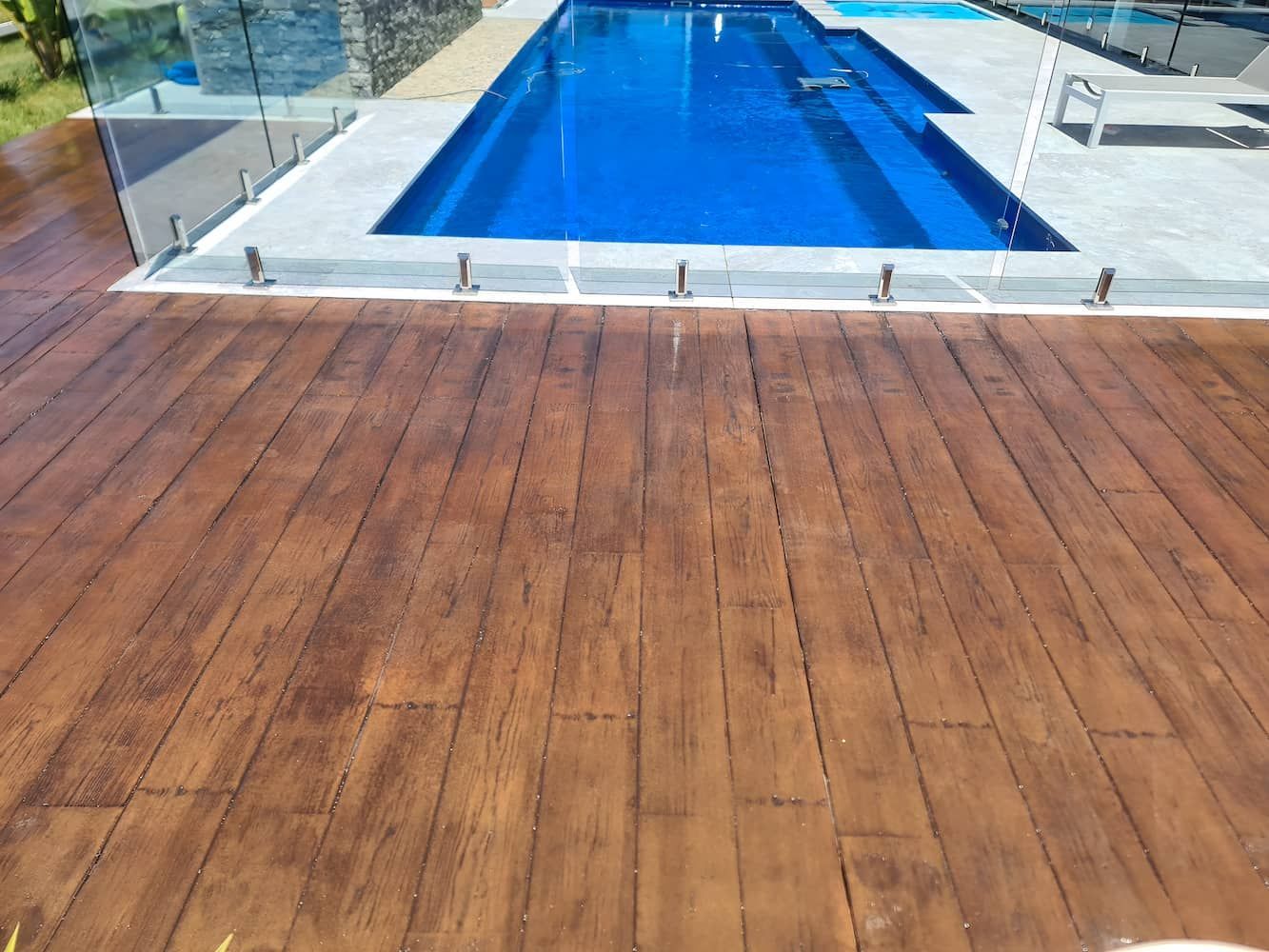 A large swimming pool with a wooden deck in front of it— That Painter Guy In South Nowra, NSW