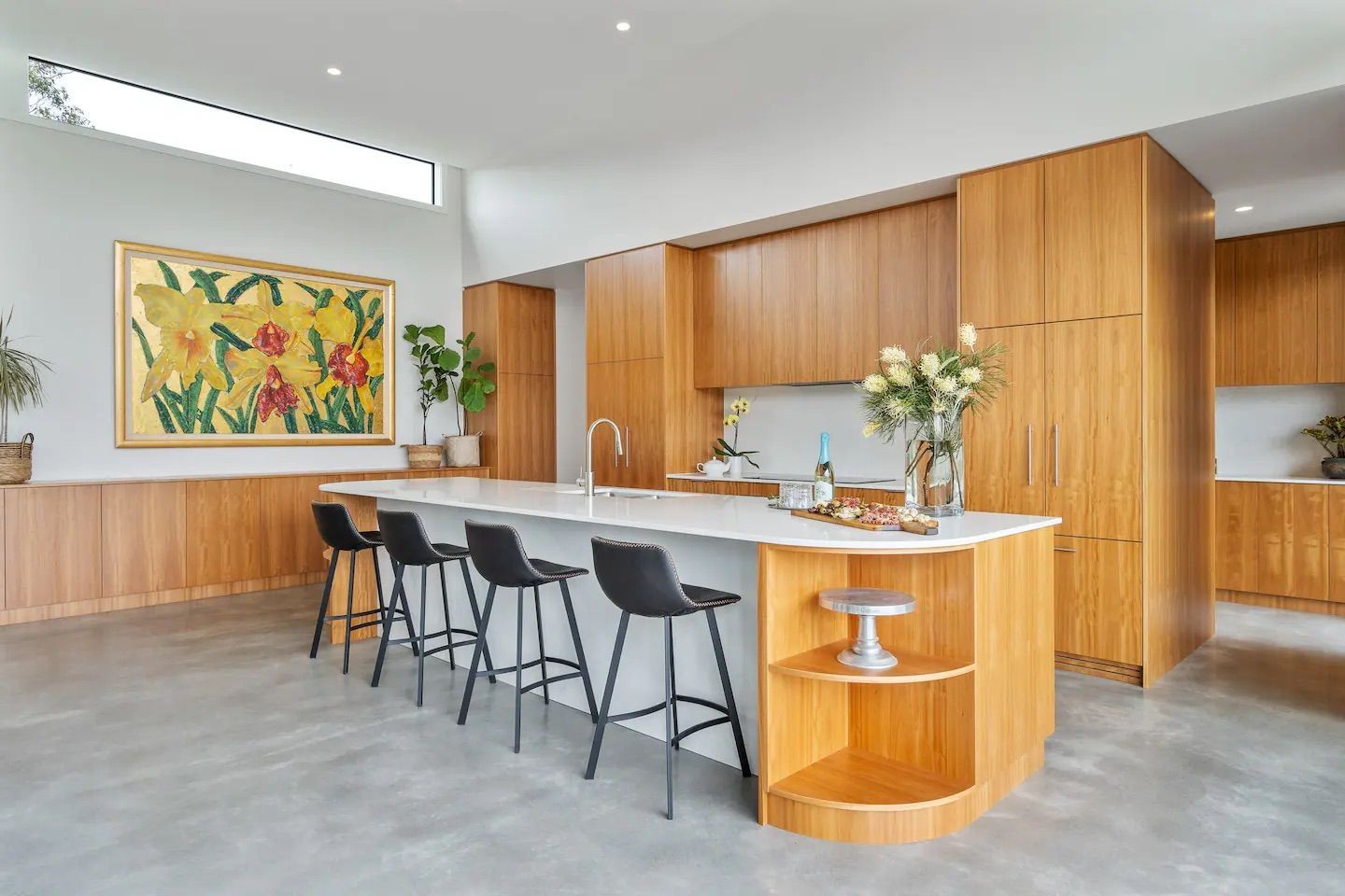 A kitchen with a large island and stools and a painting on the wall.— That Painter Guy In South Nowra, NSW