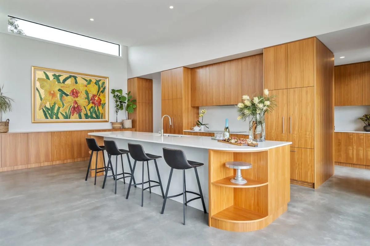 A Kitchen With A Large Island and Stools and A Painting On The Wall  — That Painter Guy In South Nowra, NSW