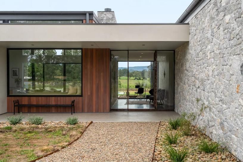 A Modern House With A Stone Wall and Sliding Glass Doors  — That Painter Guy In South Nowra, NSW