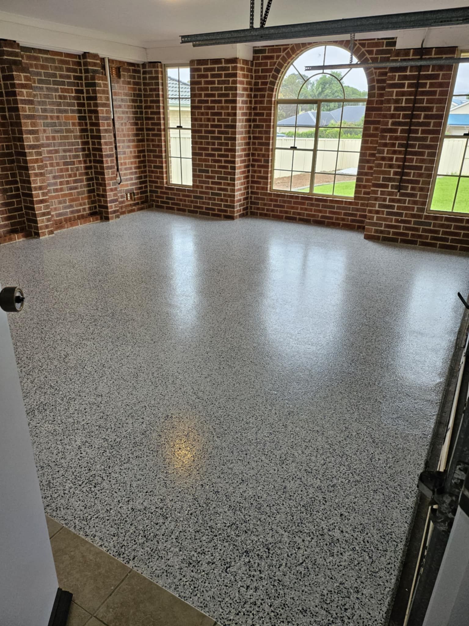 A large room with brick walls and a white floor.— That Painter Guy In South Nowra, NSW